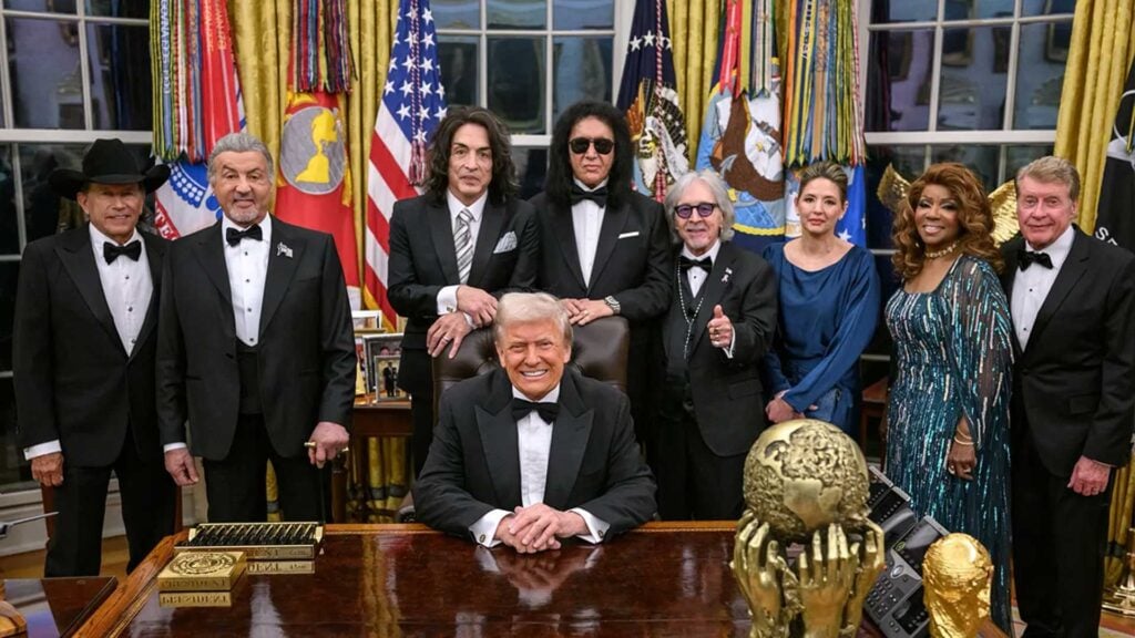 President Donald Trump at the Resolute Desk with the 2025 Kennedy Center Honorees